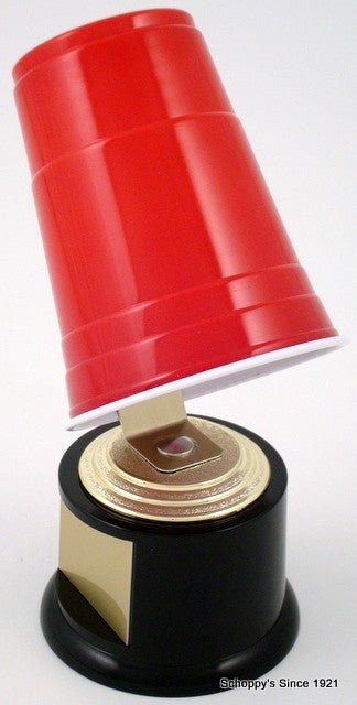 A novelty trophy shaped like an upside-down red plastic cup mounted on a black and gold base with a blank gold plaque, photographed on a white background.