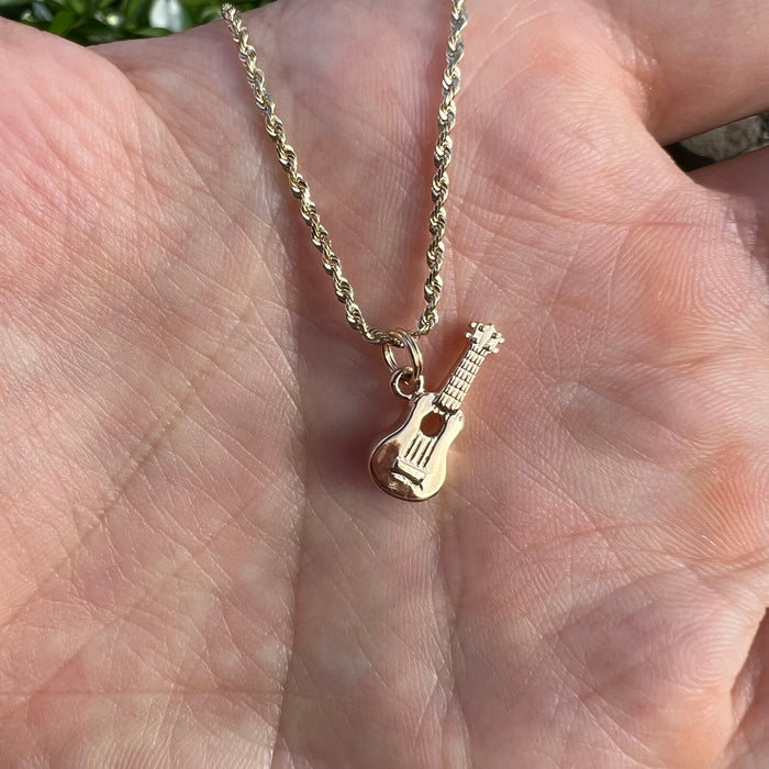 Small gold Ukulele charm pendant on a chain