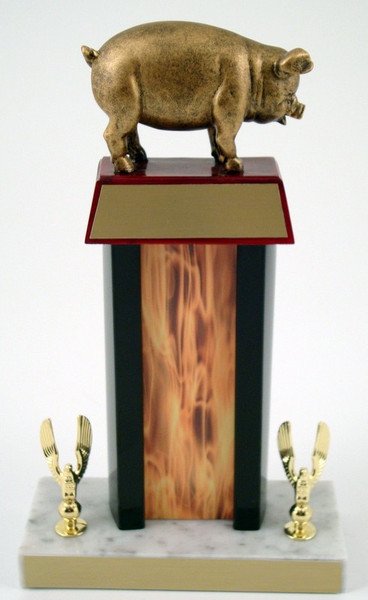 Pig Flaming Column Trophy with a pig resin figure on trapezoid wood base with gold engraving plate, all atop a white marble base that has two golden eagle figures and gold engraving plate