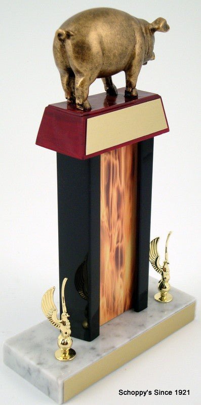 Pig Flaming Column Trophy with a pig resin figure on trapezoid wood base with gold engraving plate, all atop a white marble base that has two golden eagle figures and gold engraving plate
